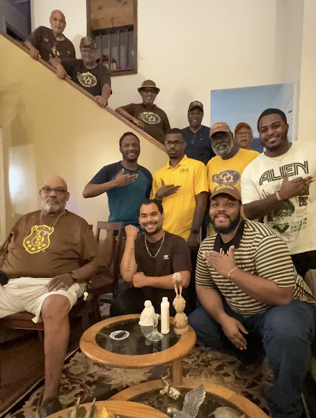 Senior and younger Brothers together at home, sharing fellowship across generations.